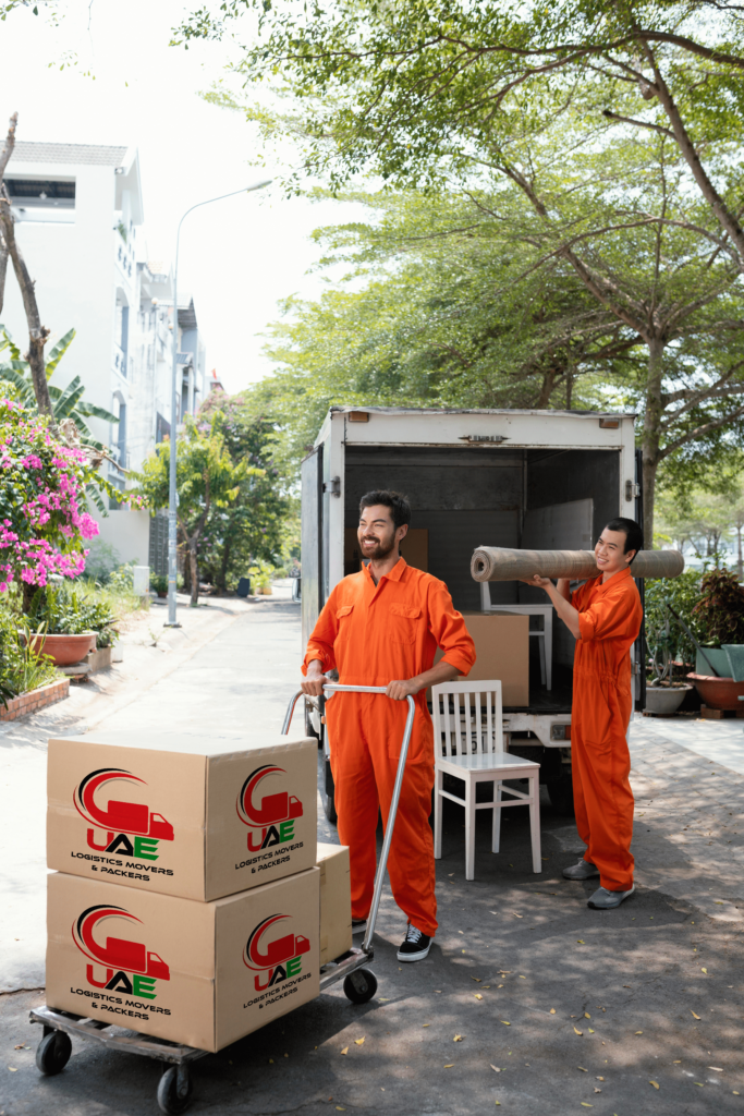 best moving service in Al Ain: Movers moving boxes outside premises